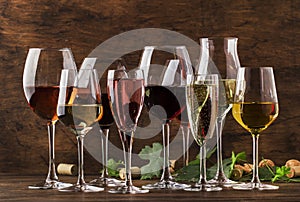 Wine tasting, still and sparkling wines. Red, white wine, rose and champagne ÃËÃâ assortment in wine glasses on vintage wooden